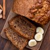 Banana bread on wooden background, top view