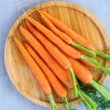 Fresh raw carrots on the wooden tray