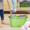 Woman in rubber gloves pouring disinfecting detergent in bucket for floor cleaning