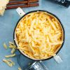 Grated cheese in brown bowl. Grated cheese.