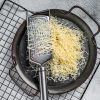 Grated cheese for cooking in a steel tray with grater. White background. Top view.
